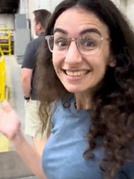 Laila smiling on the floor of the manufacturing facility